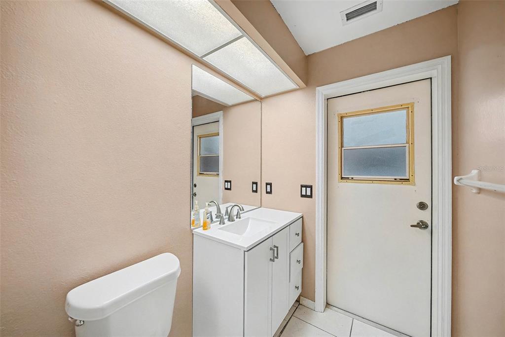 8402 Maybelle Drive Weeki Wachee, FL 34613 - Photo 29 of 41 a white toilet sitting next to a bathroom sink