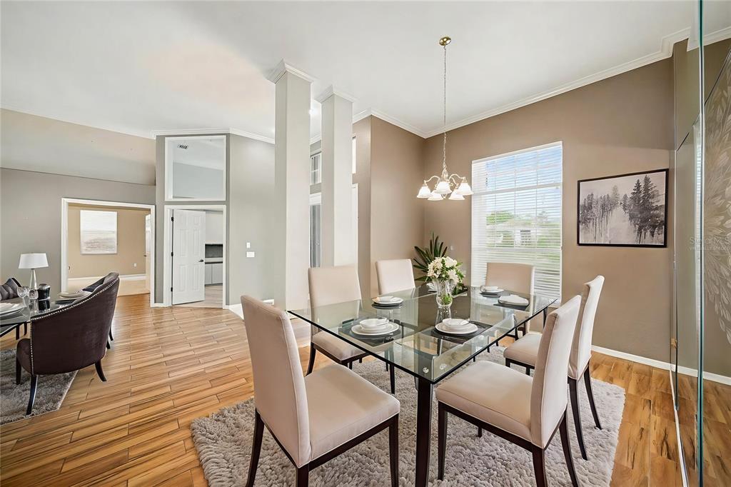 8402 Maybelle Drive Weeki Wachee, FL 34613 - Photo 10 of 41 a view of a dining room with furniture window and wooden floor