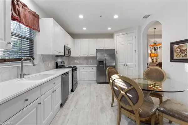 a kitchen with a sink appliances and cabinets