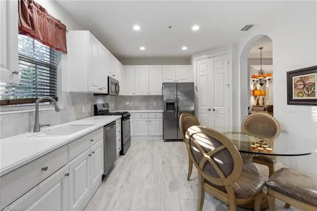 a kitchen with a sink appliances and cabinets