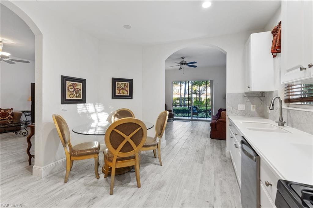 9079 Cascada Way, Unit 102 Naples, FL 34114 - Photo 16 of 49 a view of a dining room with furniture and window