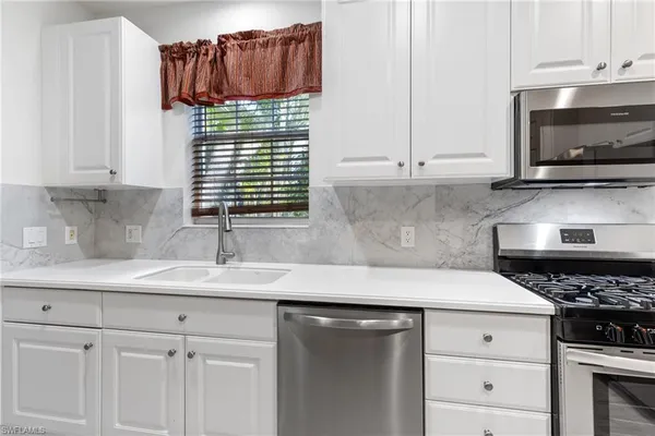 a kitchen with a sink and a stove