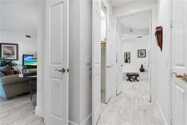 a view of a bedroom with a furniture and mirror