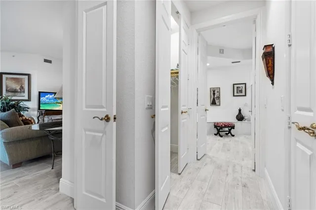 a view of a bedroom with a furniture and mirror