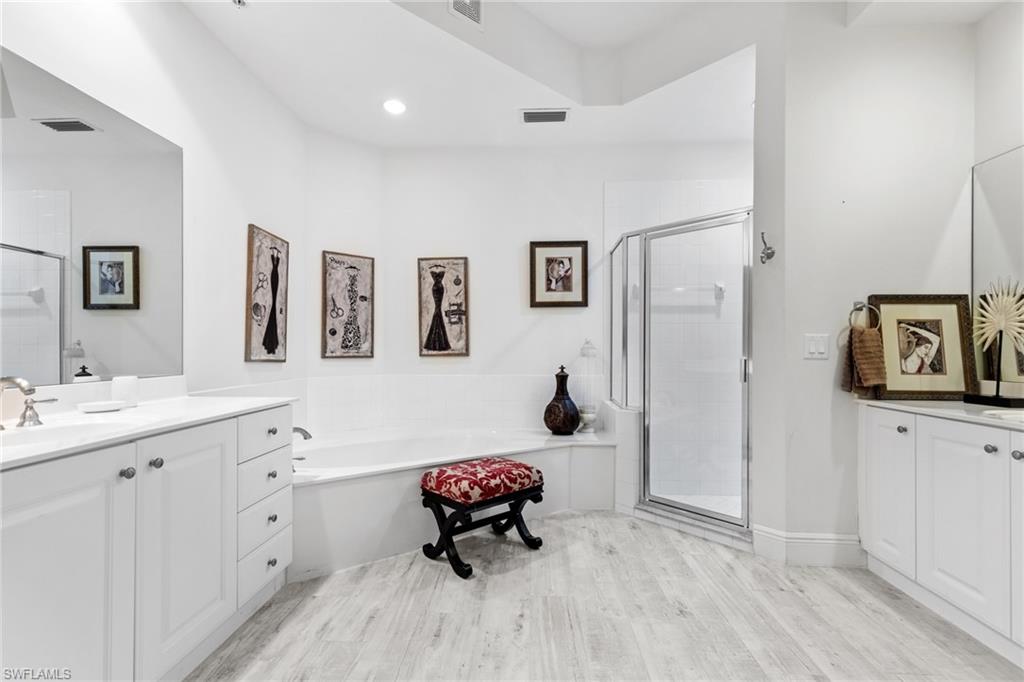 9079 Cascada Way, Unit 102 Naples, FL 34114 - Photo 28 of 49 a bedroom with a bed and a bathroom