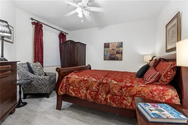 a bed sitting in a bedroom next to a window