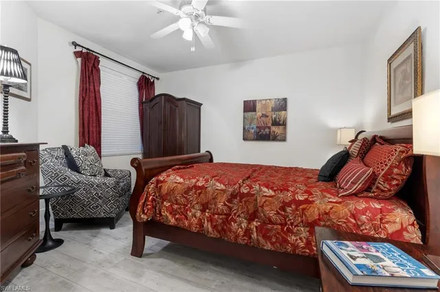 a bed sitting in a bedroom next to a window