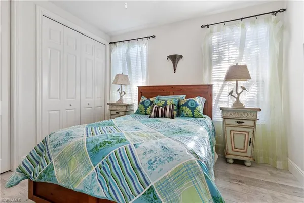 a bedroom with a bed dresser and a window