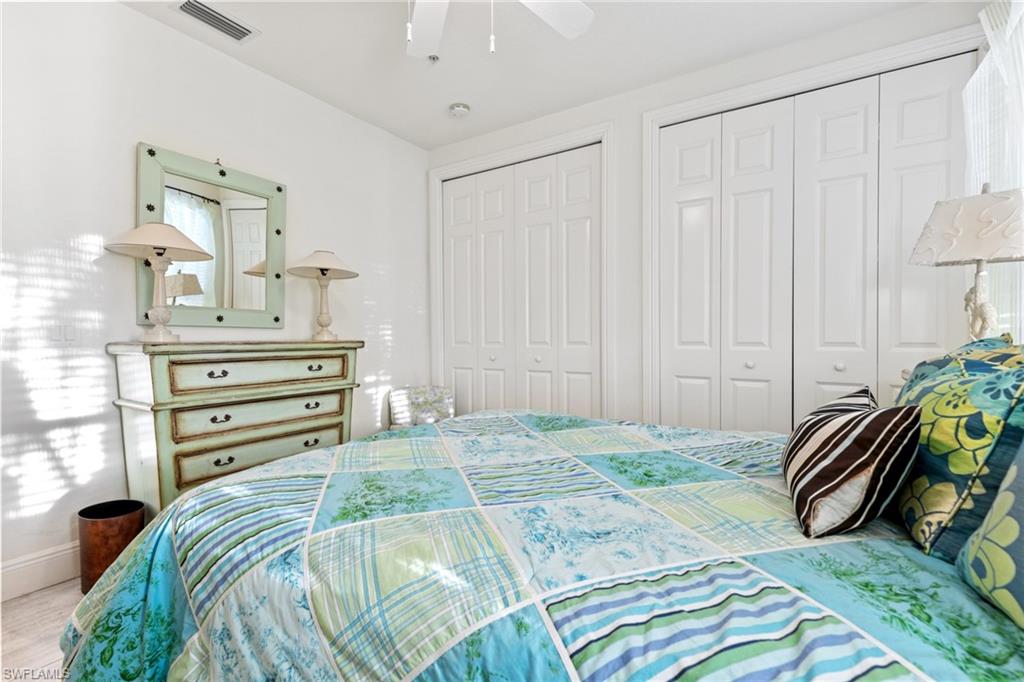 9079 Cascada Way, Unit 102 Naples, FL 34114 - Photo 36 of 49 a view of a bedroom with a bed and a chandelier