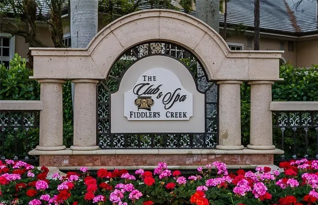 a sign that is in front of flowers