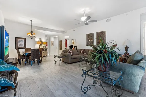 a living room with furniture and a chandelier