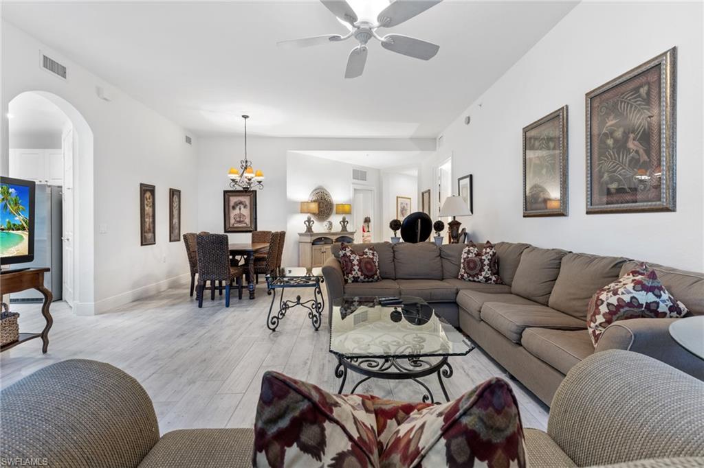 9079 Cascada Way, Unit 102 Naples, FL 34114 - Photo 6 of 49 a living room with furniture and a flat screen tv
