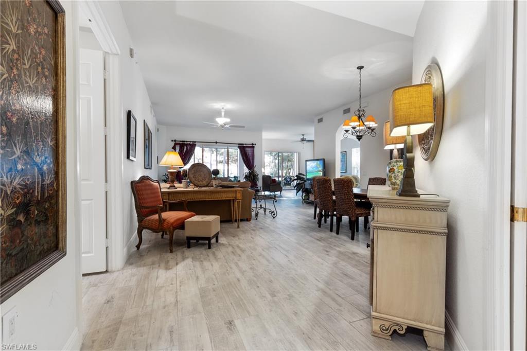 9079 Cascada Way, Unit 102 Naples, FL 34114 - Photo 7 of 49 a living room with furniture and a fireplace