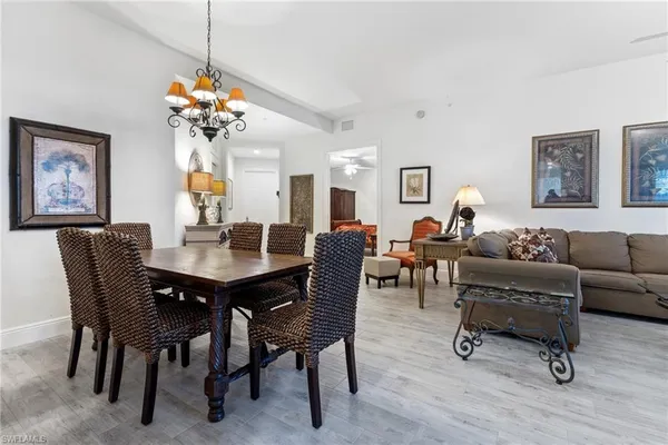 a view of a dining room with furniture and chandelier