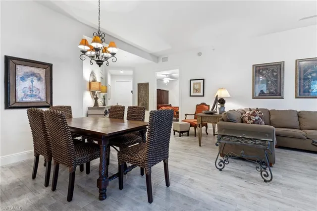 a view of a dining room with furniture and chandelier