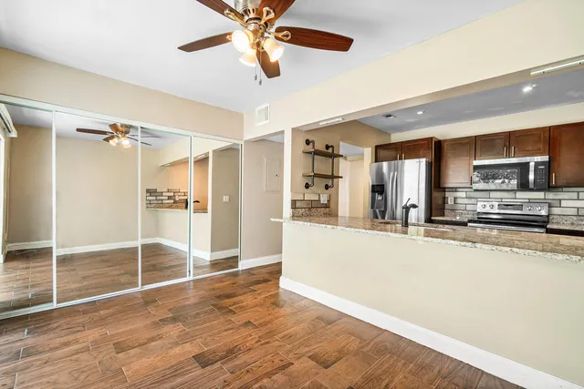 a view of a kitchen with a sink and microwave