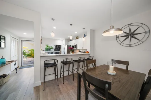 a view of a dining room with furniture and wooden floor