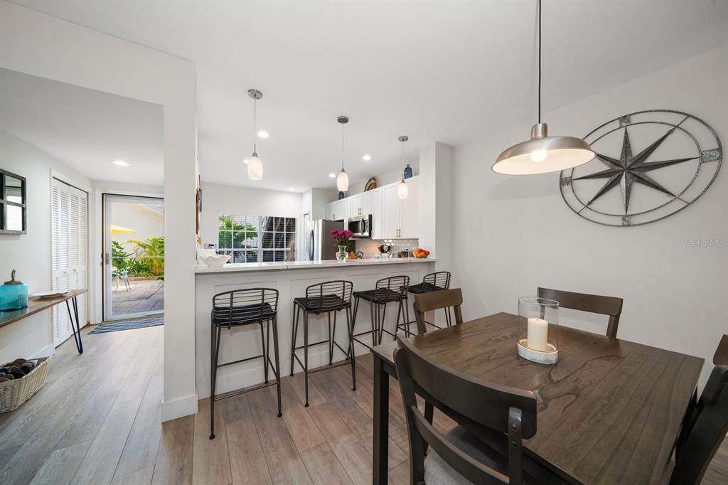 11300 Harbor Way, Unit 1734 Largo, FL 33774 - Photo 15 of 44 a view of a dining room with furniture and wooden floor