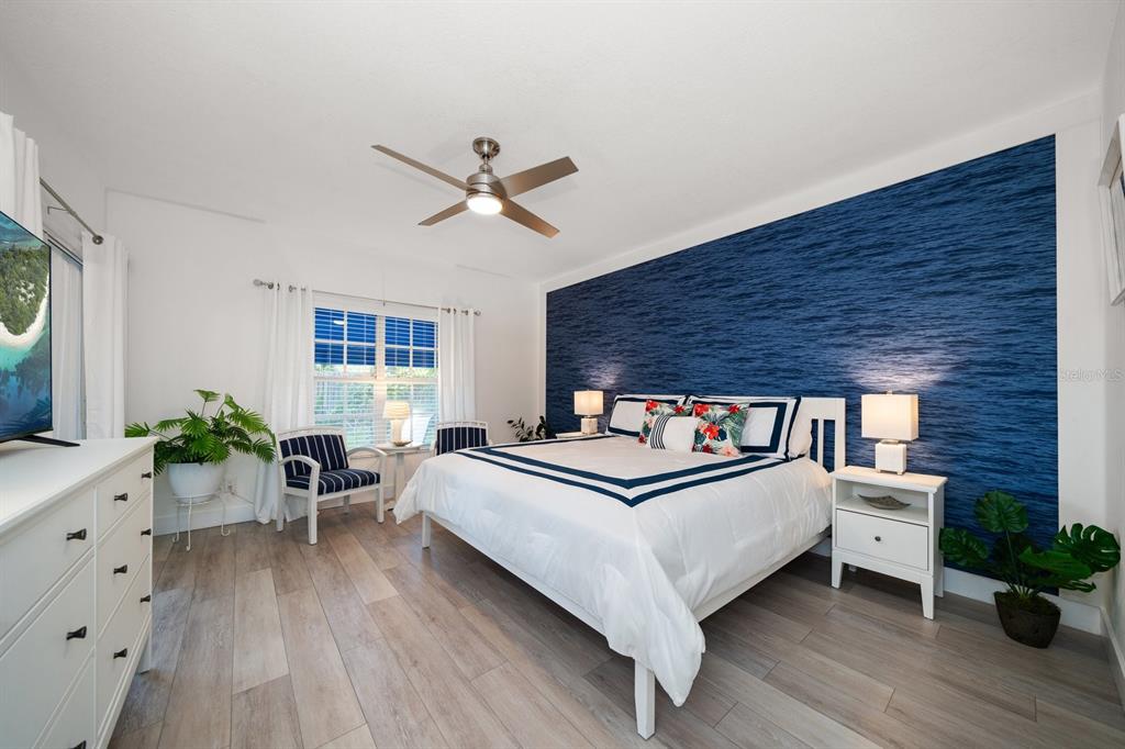 11300 Harbor Way, Unit 1734 Largo, FL 33774 - Photo 17 of 44 a bed room with a bed and a chair