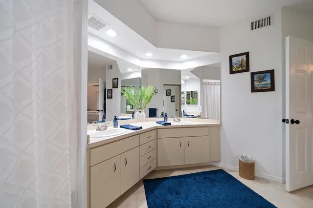 a bathroom with a double vanity sink and mirror