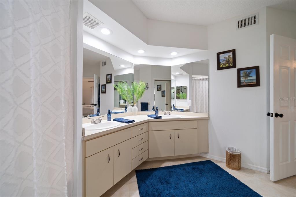 11300 Harbor Way, Unit 1734 Largo, FL 33774 - Photo 19 of 44 a bathroom with a double vanity sink and mirror