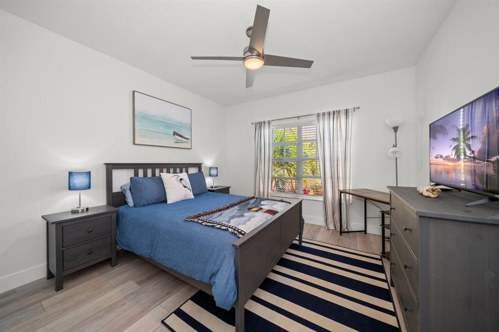 11300 Harbor Way, Unit 1734 Largo, FL 33774 - Photo 21 of 44 a bedroom with a bed and a chandelier