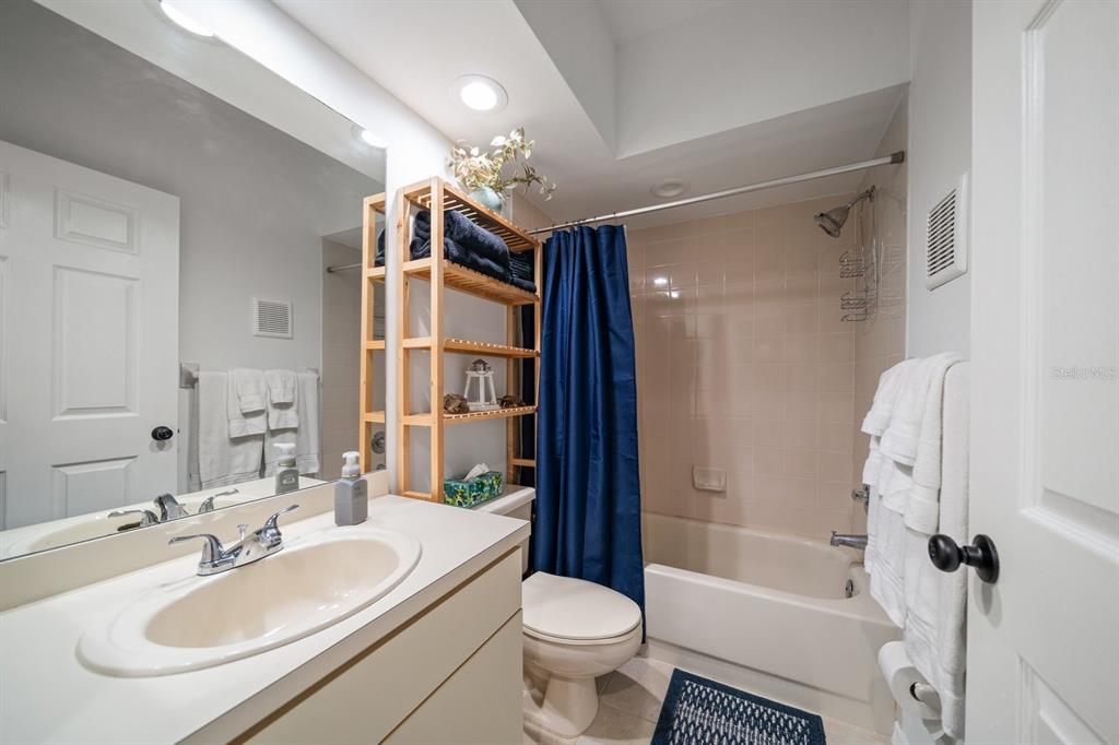 11300 Harbor Way, Unit 1734 Largo, FL 33774 - Photo 22 of 44 a bathroom with a sink toilet tub and shower