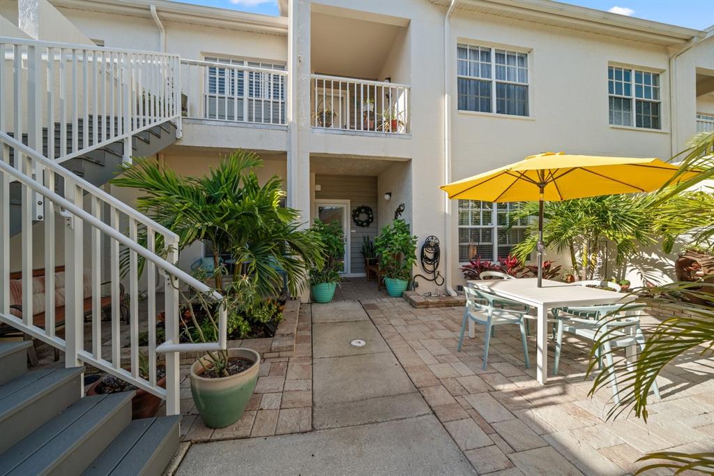 11300 Harbor Way, Unit 1734 Largo, FL 33774 - Photo 25 of 44 a view of a chair and table in the patio with a fire pit