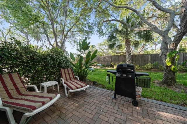 a view of a chairs and table in backyard