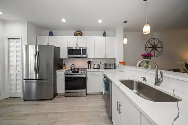 a kitchen with a sink cabinets and stainless steel appliances