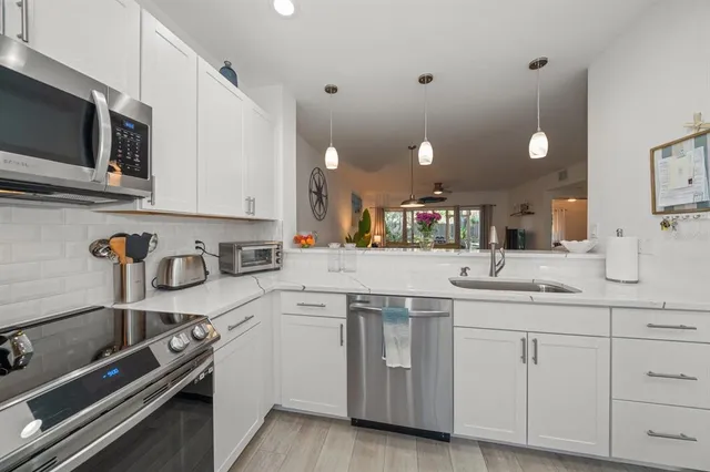 a kitchen with a sink stove and cabinets