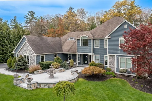 a front view of a house with a garden and outdoor seating