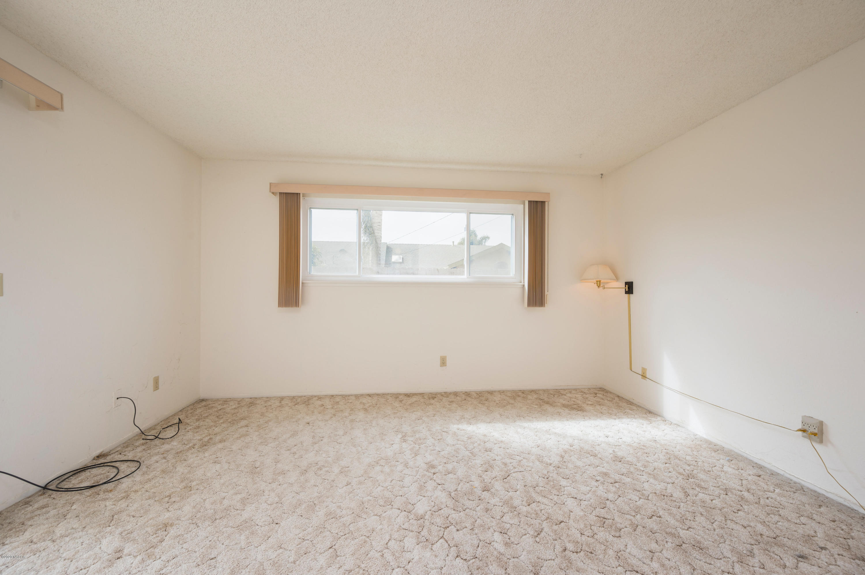 1008 West Anthony Way Lompoc, CA 93436 - Photo 12 of 26 an empty room with a window