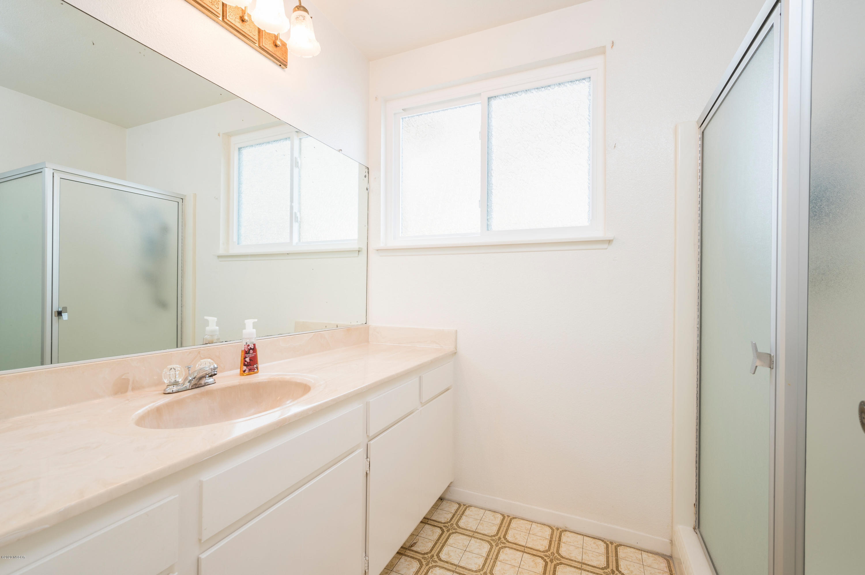 1008 West Anthony Way Lompoc, CA 93436 - Photo 15 of 26 a bathroom with a sink and a mirror