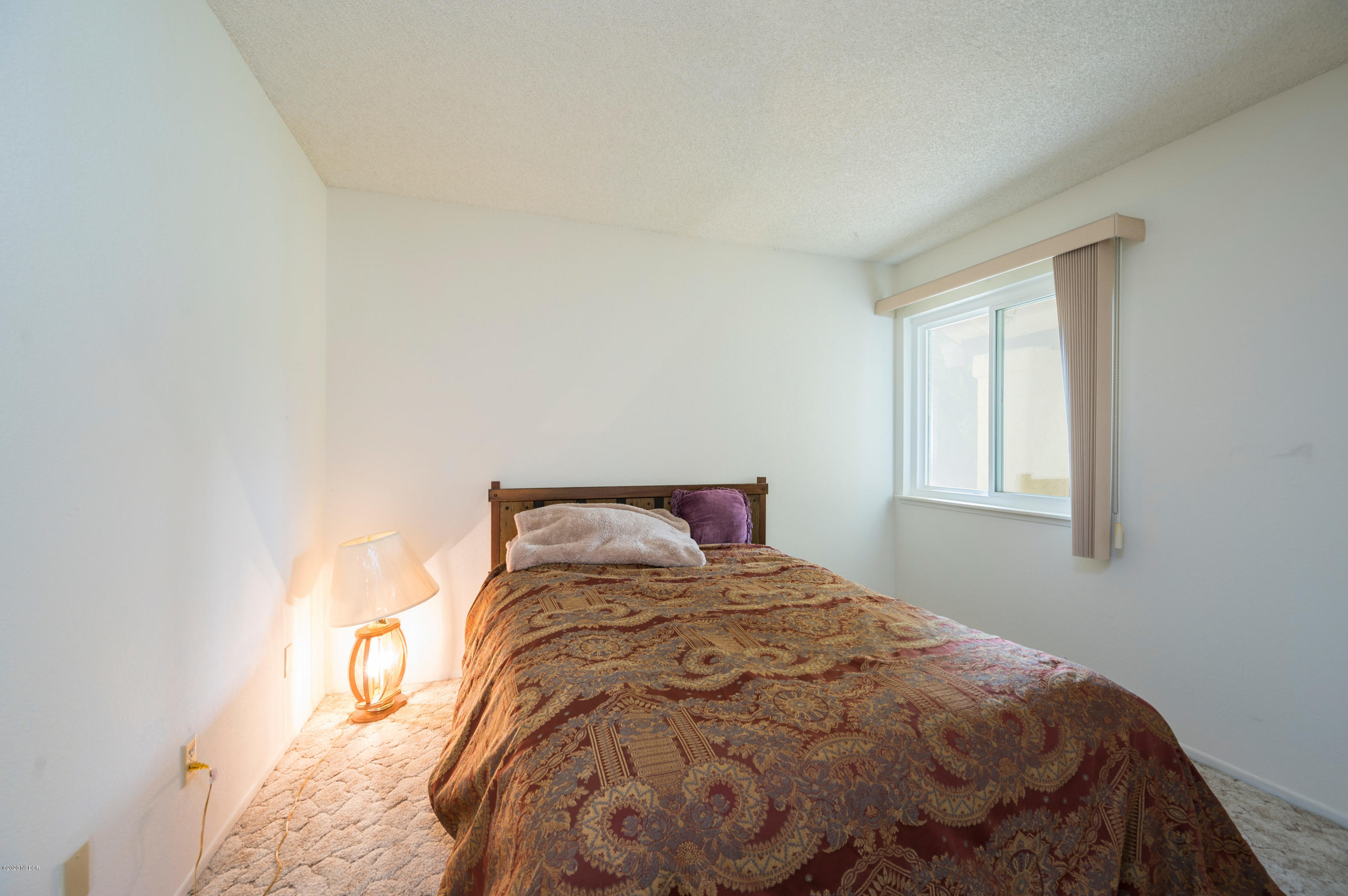 1008 West Anthony Way Lompoc, CA 93436 - Photo 16 of 26 a bed sitting in a bedroom next to a window