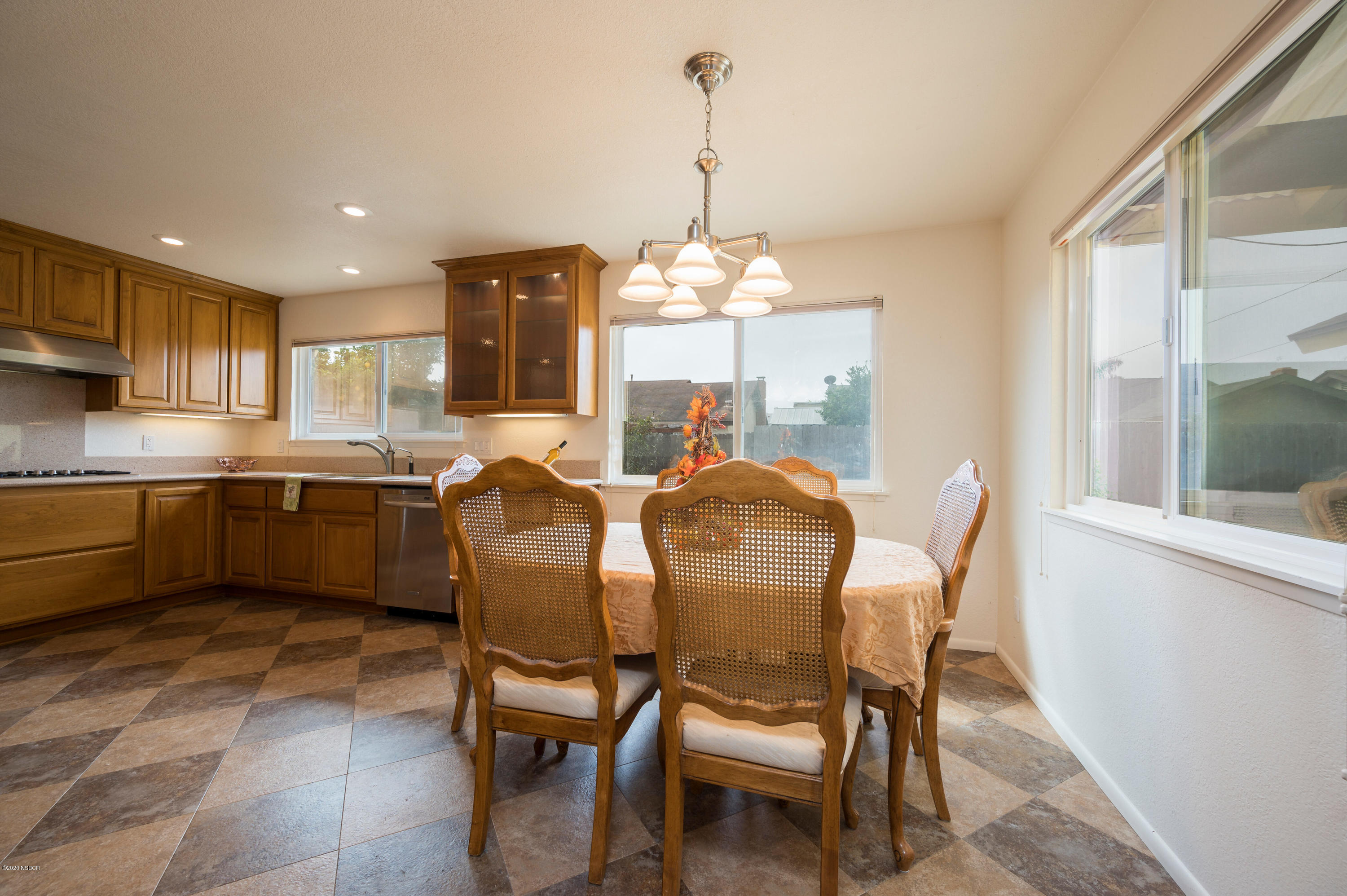 1008 West Anthony Way Lompoc, CA 93436 - Photo 8 of 26 a view of a dining room with furniture and chandelier