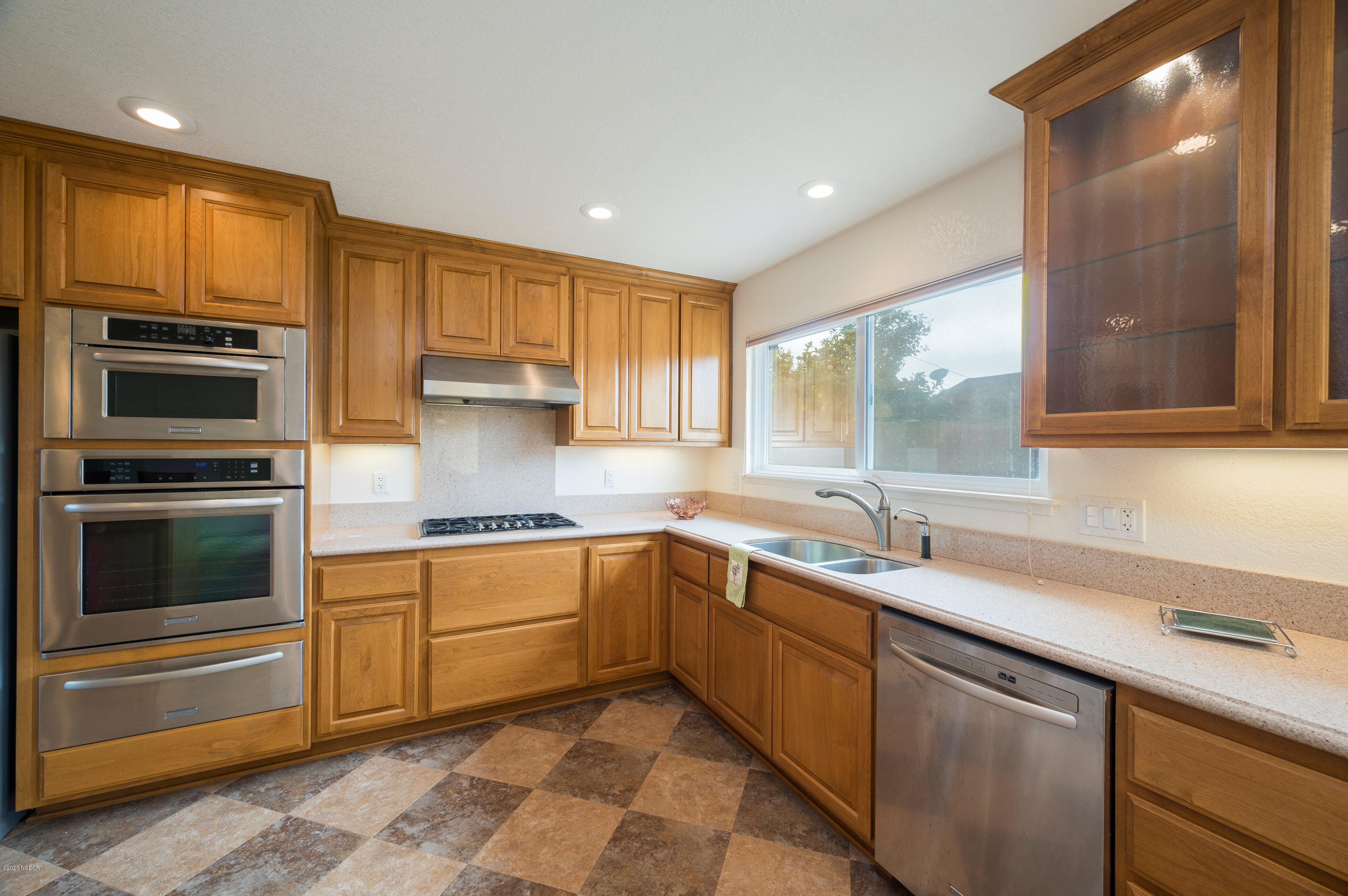 1008 West Anthony Way Lompoc, CA 93436 - Photo 9 of 26 a kitchen with a sink stove and microwave