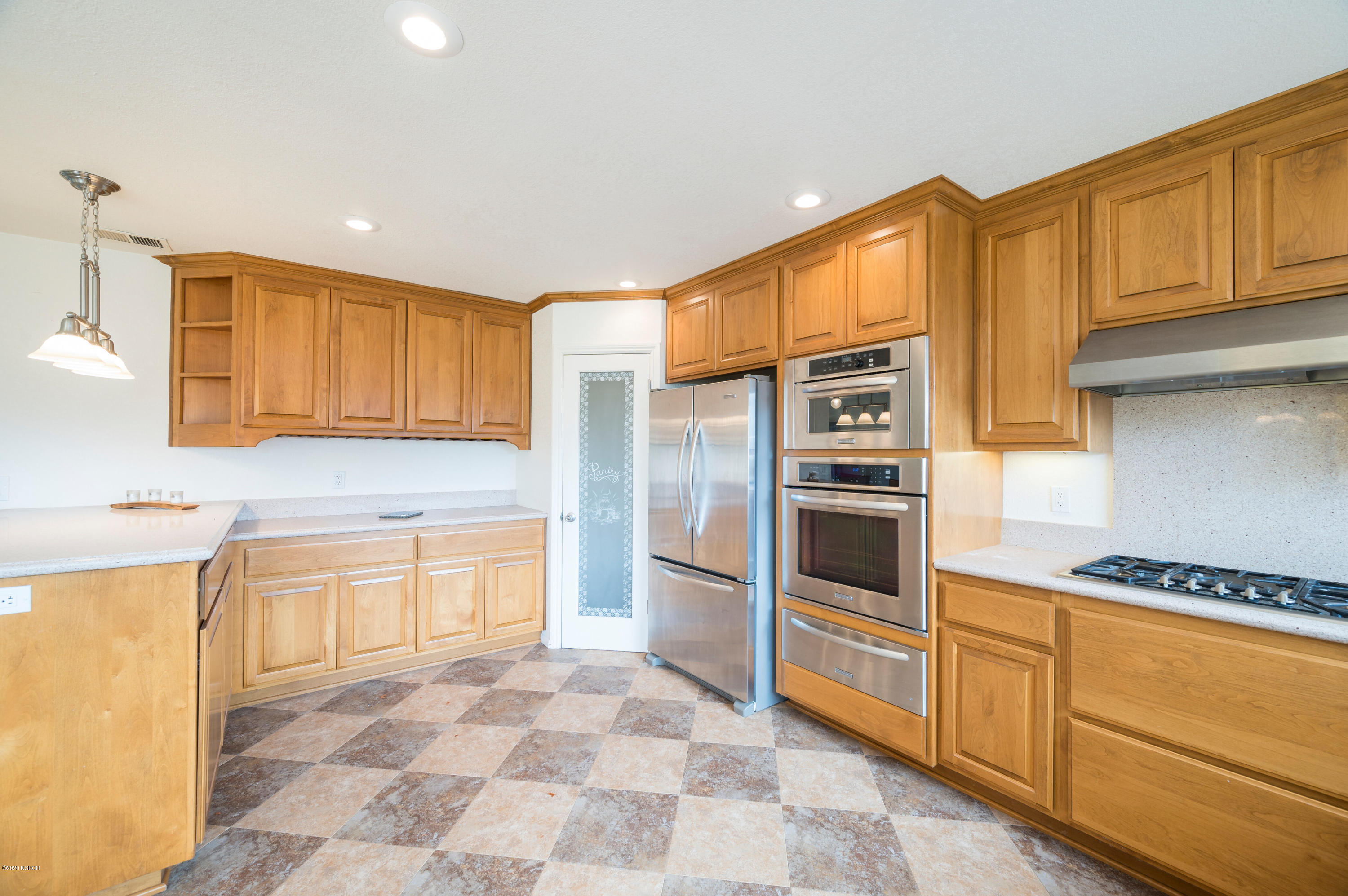 1008 West Anthony Way Lompoc, CA 93436 - Photo 10 of 26 a kitchen with stainless steel appliances granite countertop a refrigerator and a stove top oven