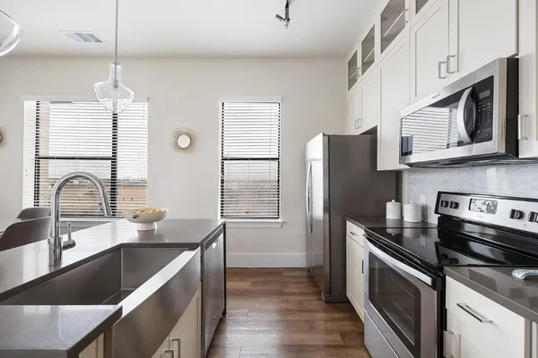 a living room with stainless steel appliances kitchen island granite countertop furniture and a view of kitchen