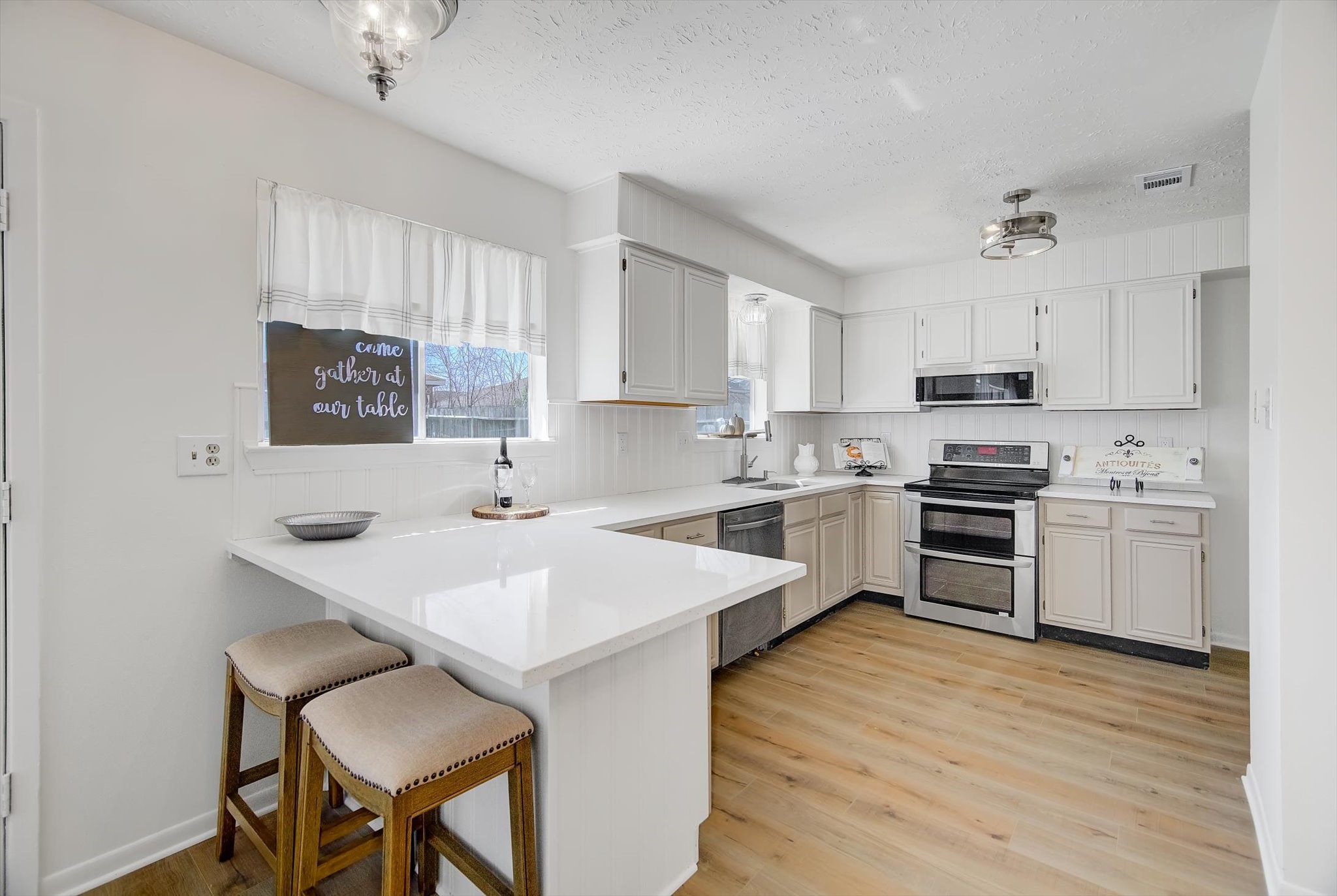 15110 Peachmeadow Lane Channelview, TX 77530 - Photo 14 of 34 a kitchen with a sink white cabinets and stainless steel appliances
