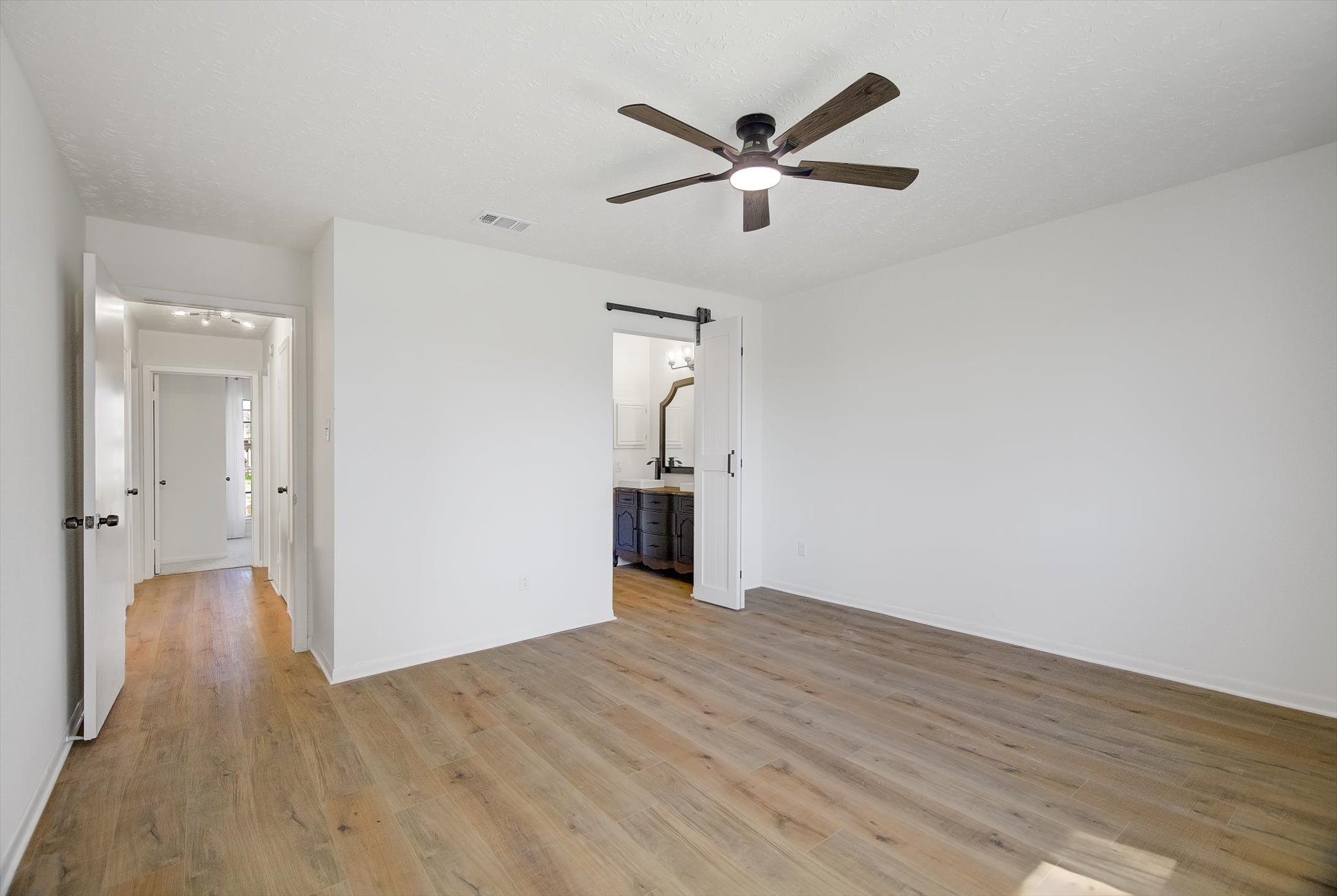 15110 Peachmeadow Lane Channelview, TX 77530 - Photo 18 of 34 an empty room with wooden floor and windows
