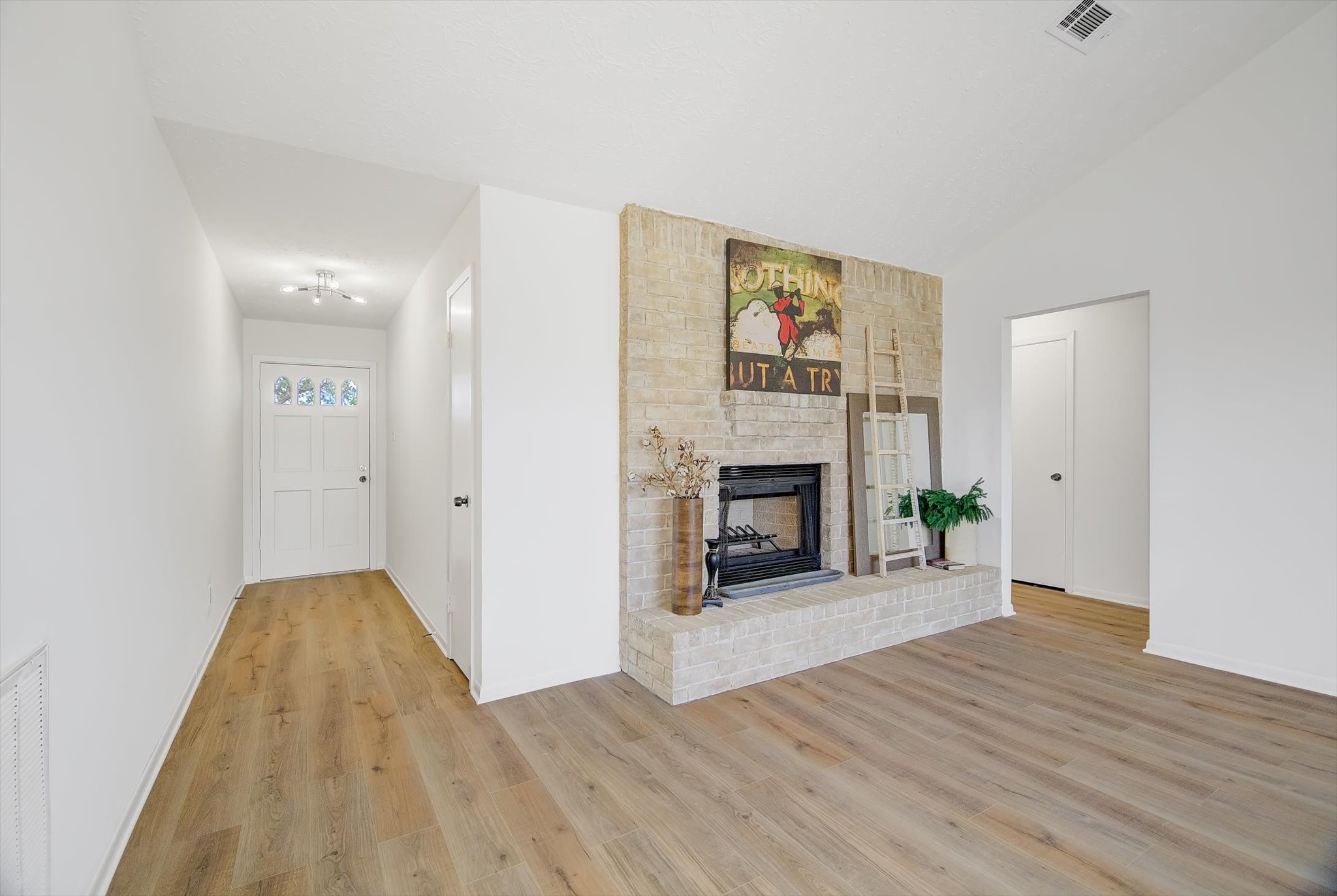 15110 Peachmeadow Lane Channelview, TX 77530 - Photo 6 of 34 a view of a livingroom with wooden floor and a fireplace