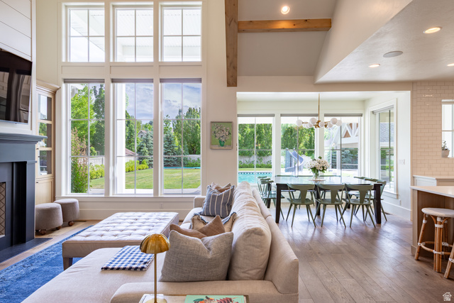 630 East Center Street Alpine, UT 84004 - Photo 35 of 115 Spacious living area featuring floor-to-ceiling windows, a dark-toned fireplace with mantel, and built-in cabinetry