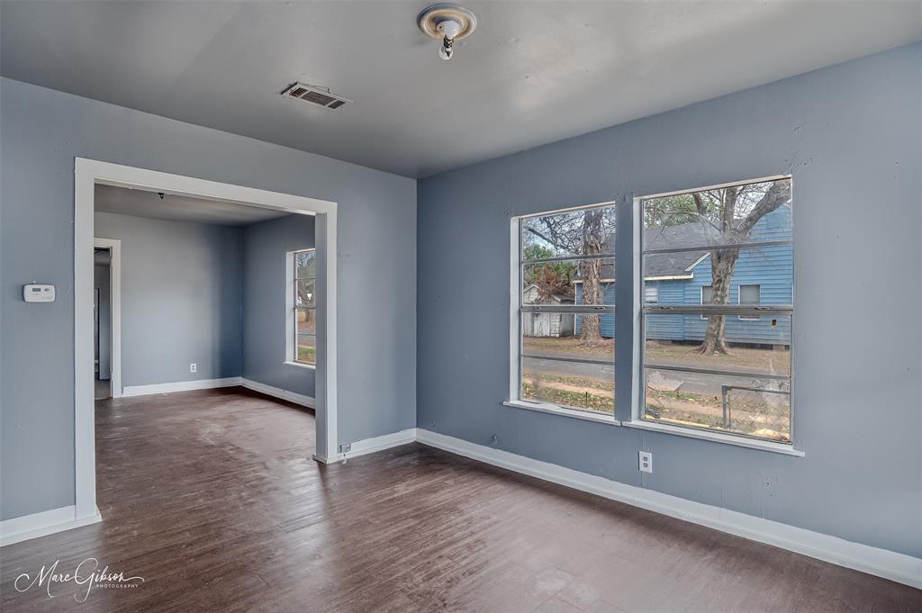 329 Edwards Street Bossier City, LA 71111 - Photo 10 of 12 a view of an empty room with a window and wooden floor