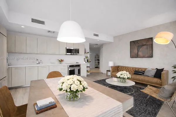 a living room with furniture fireplace and a table