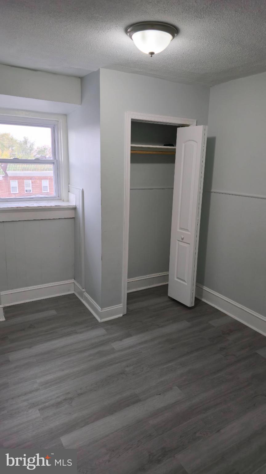 2413 Reisterstown Road Baltimore, MD 21217 - Photo 15 of 22 an empty room with wooden floor and windows