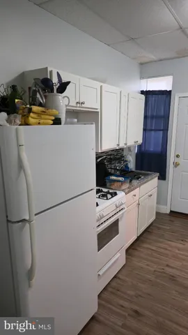 a kitchen with a refrigerator and a stove
