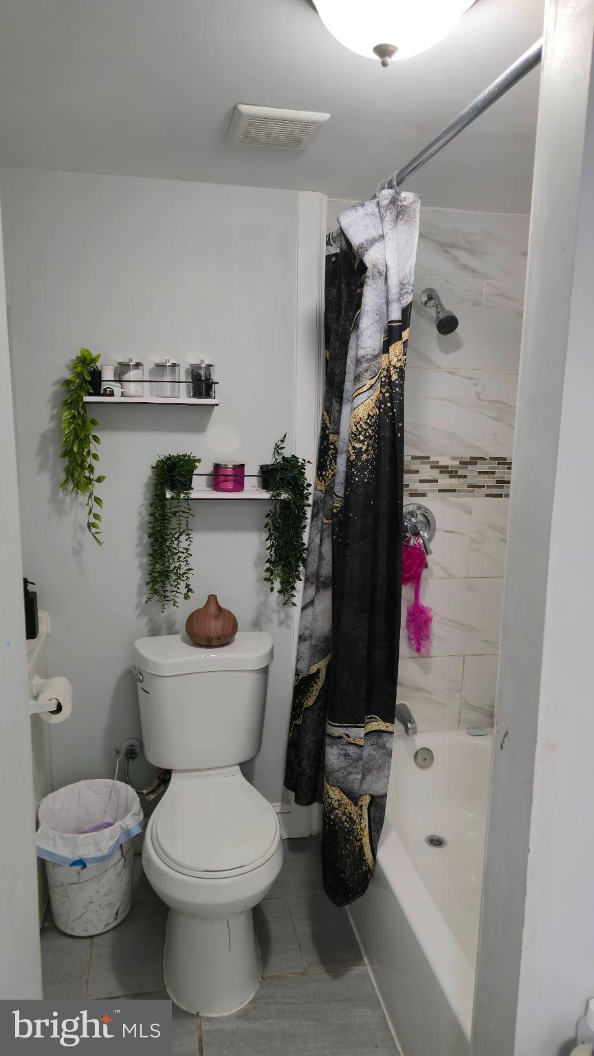 2413 Reisterstown Road Baltimore, MD 21217 - Photo 10 of 22 a bathroom with a toilet and a tub