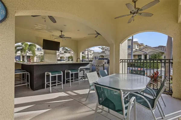 a view of a backyard with a table and chairs under an umbrella