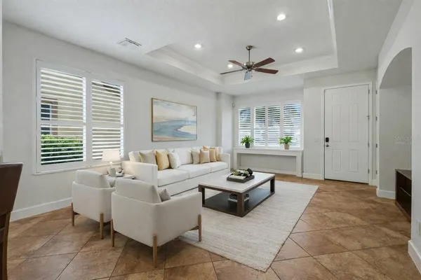 a kitchen with granite countertop a stove a sink a dining table and chairs